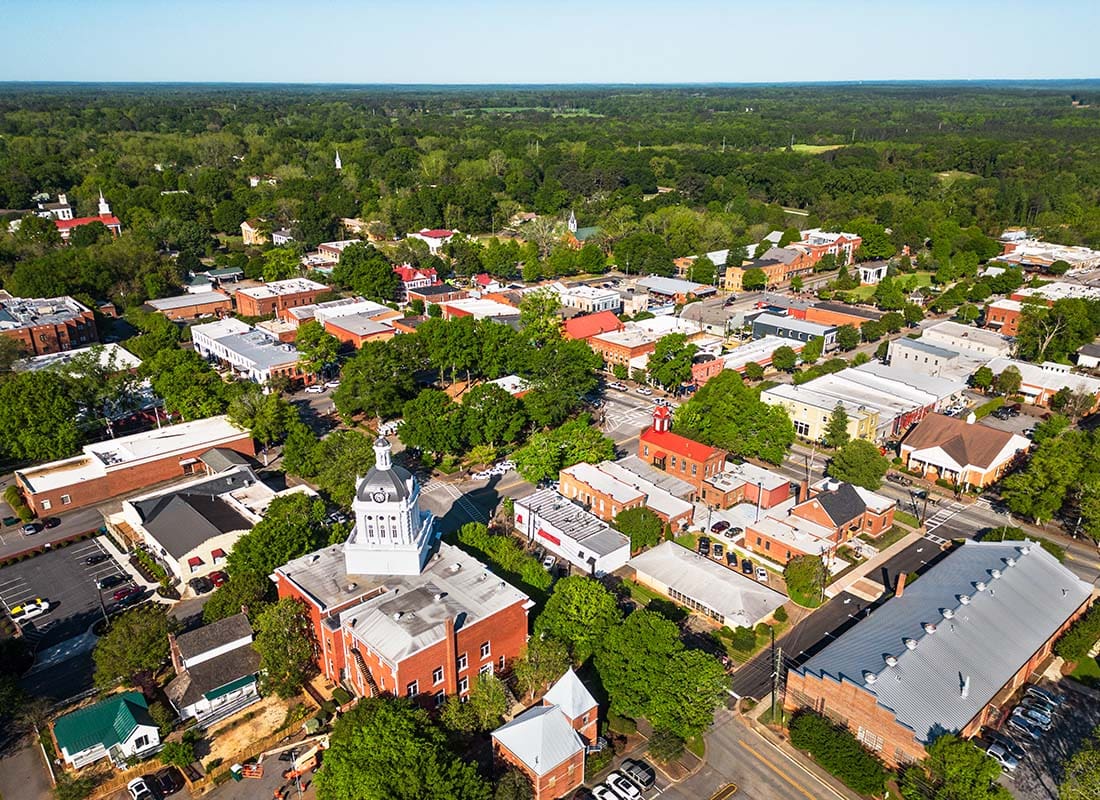 Cairo, GA - Aerial View of a Church and Other Buildings Surroudned by Green Trees in Downtown Cairo Georgia on a Sunny Day